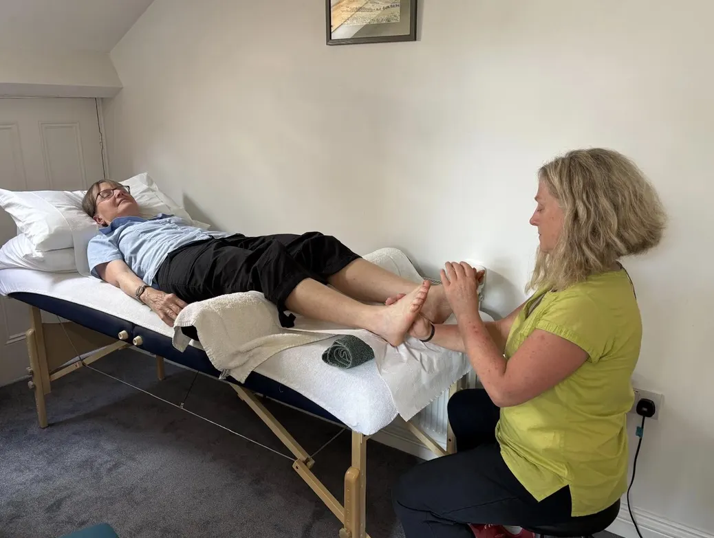 Janey giving a reflexology session in her calm practice room